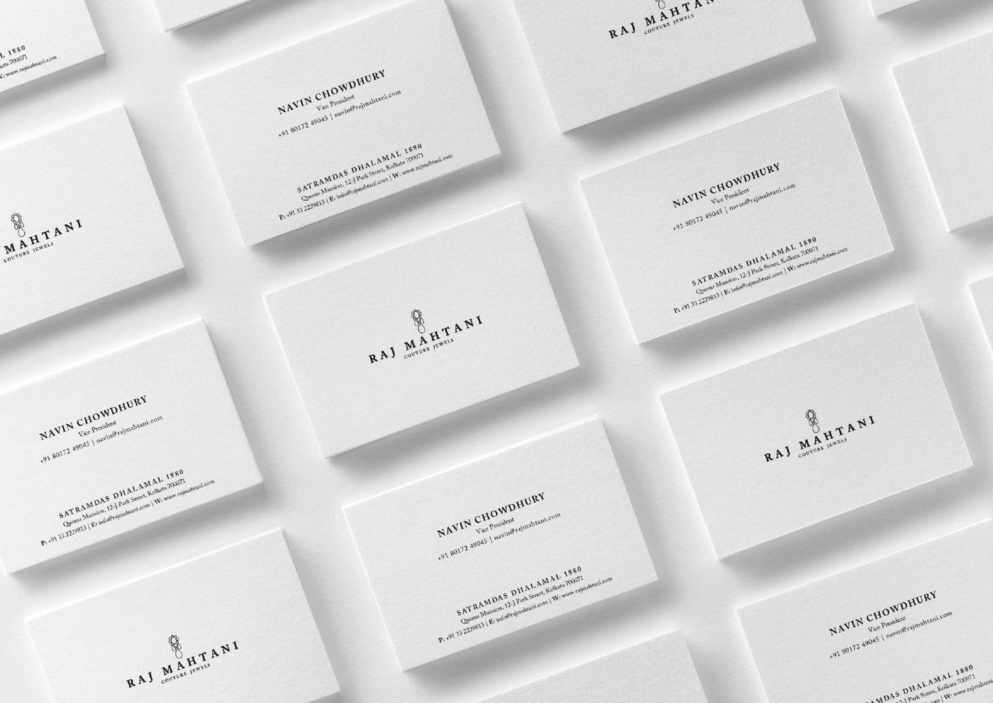 A business card system shown as a scattered arrangement of printed cards